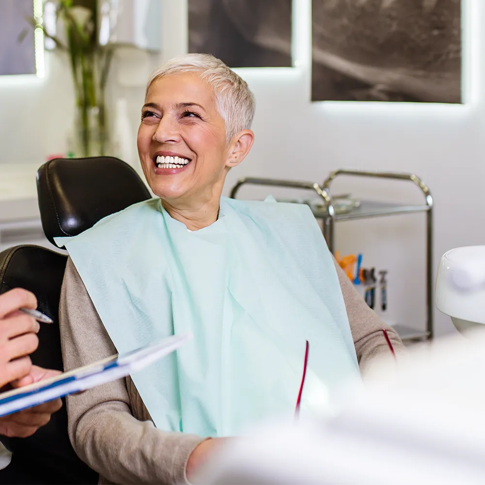 older woman at dentist smiling