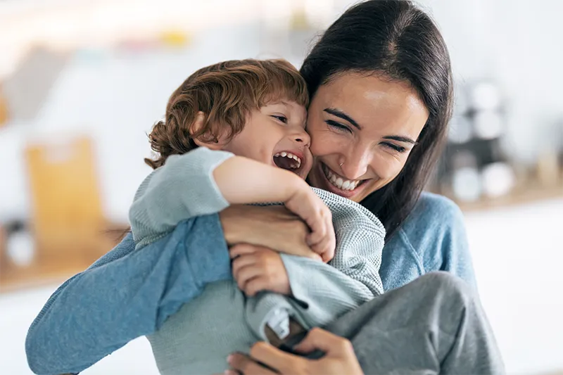 woman and child smiling in embrace