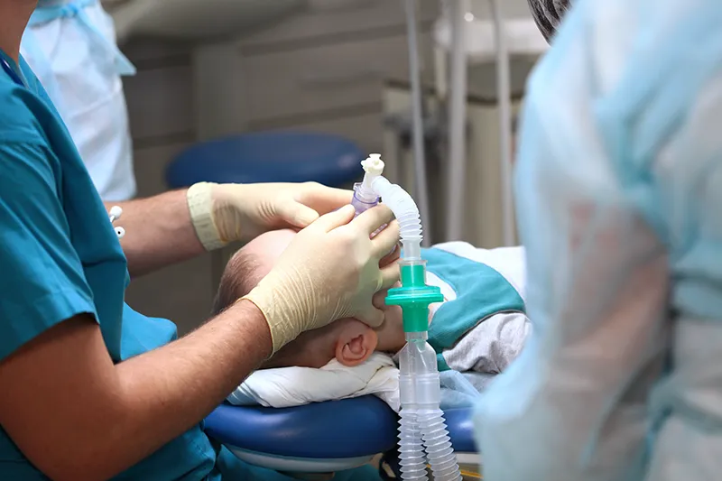 doctors applying mask to baby